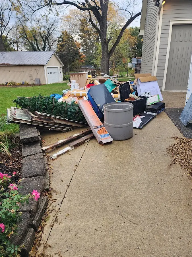 Dumpster being loaded with debris for Estate Cleanout Dumpster Rental in Hereford